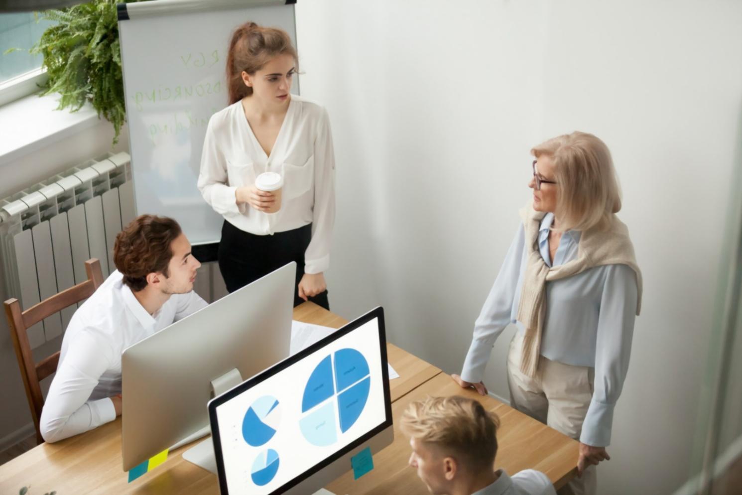 Financial planning consultation showing charts and documents on a desk